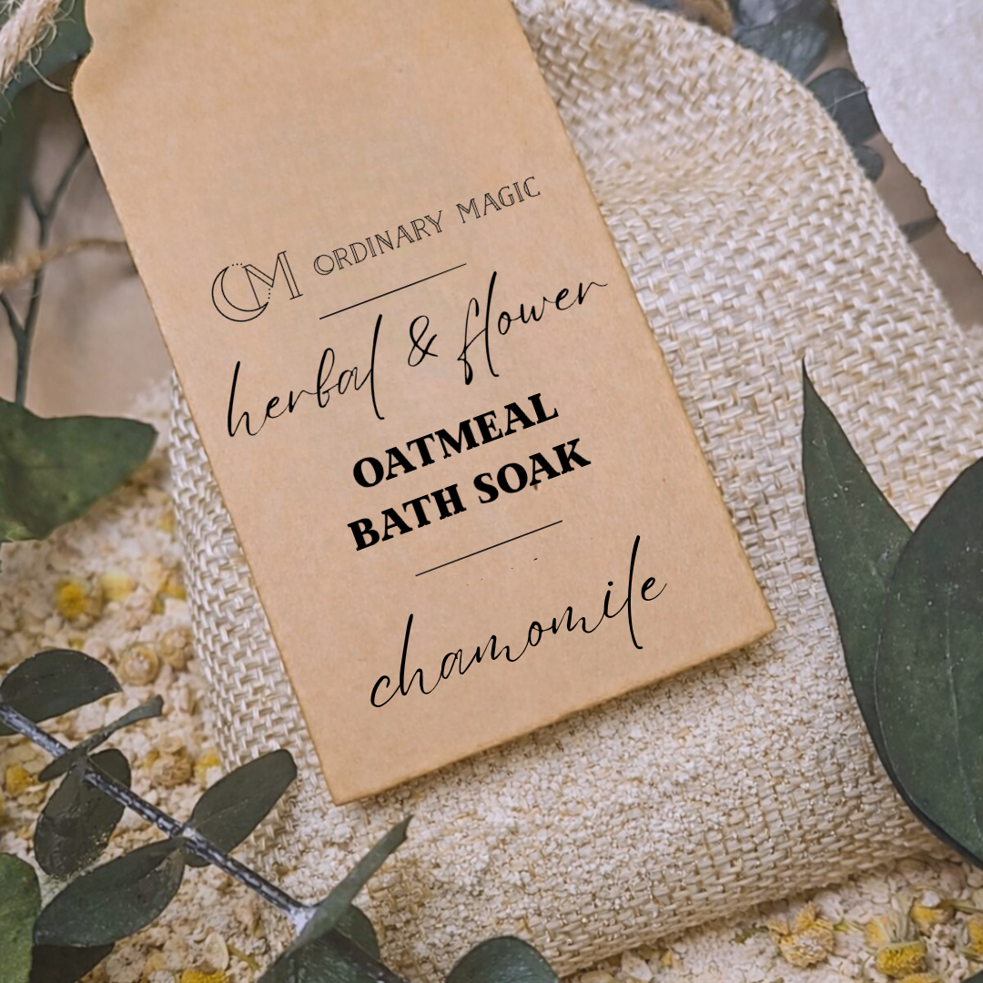 Bath soak packaging with 'Ordinary Magic' branding on a textured surface with green leaves.