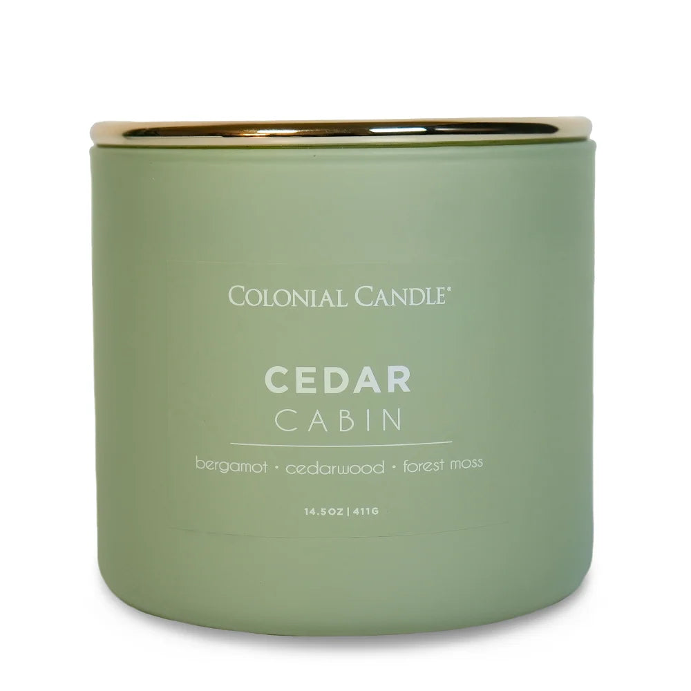 Cedar Cabin three-wick jar candle in frosted sage green glass with a gold lid