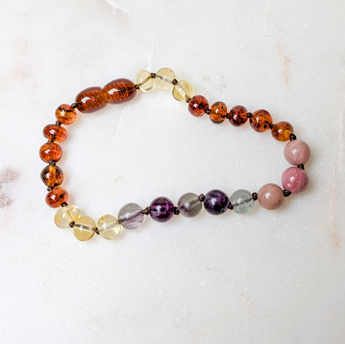 Close-up of the Baltic Sea amber and stone rainbow anklet or bracelet.