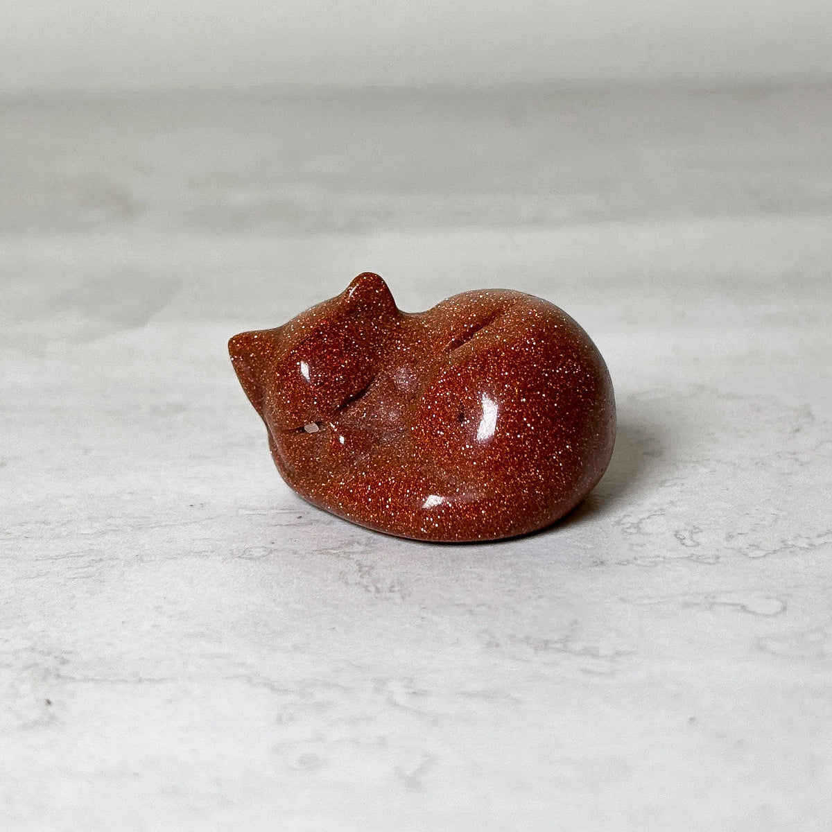 Polished red goldstone sleeping cat crystal carving, view 7, at Ordinary Magic in Savannah, GA.