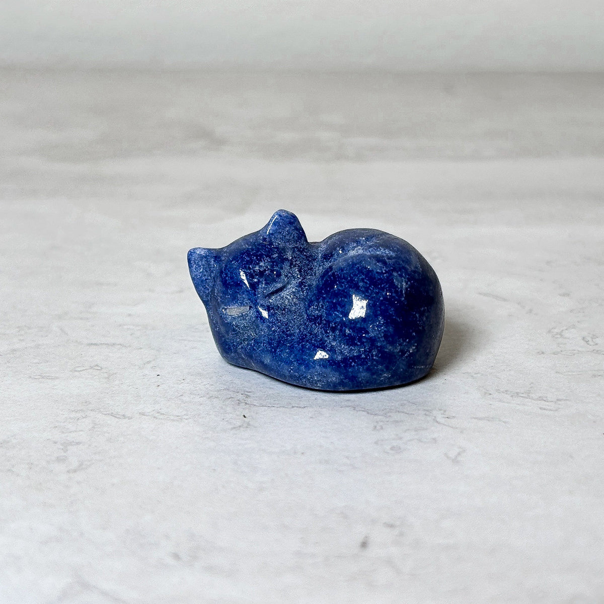 Polished sleeping cat lapis crystal carving, view 6, at Ordinary Magic in Savannah, GA.