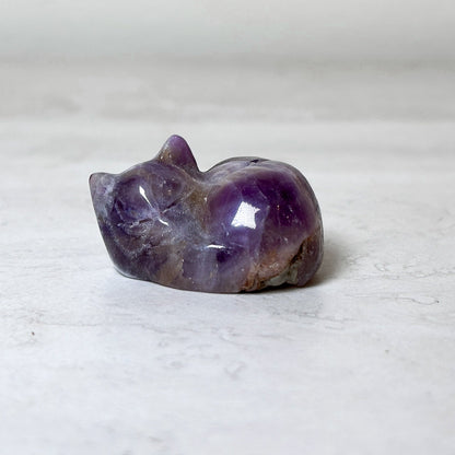 Polished sleeping cat, purple methystcrystal carving, view 12, at Ordinary Magic in Savannah, GA. 1", 