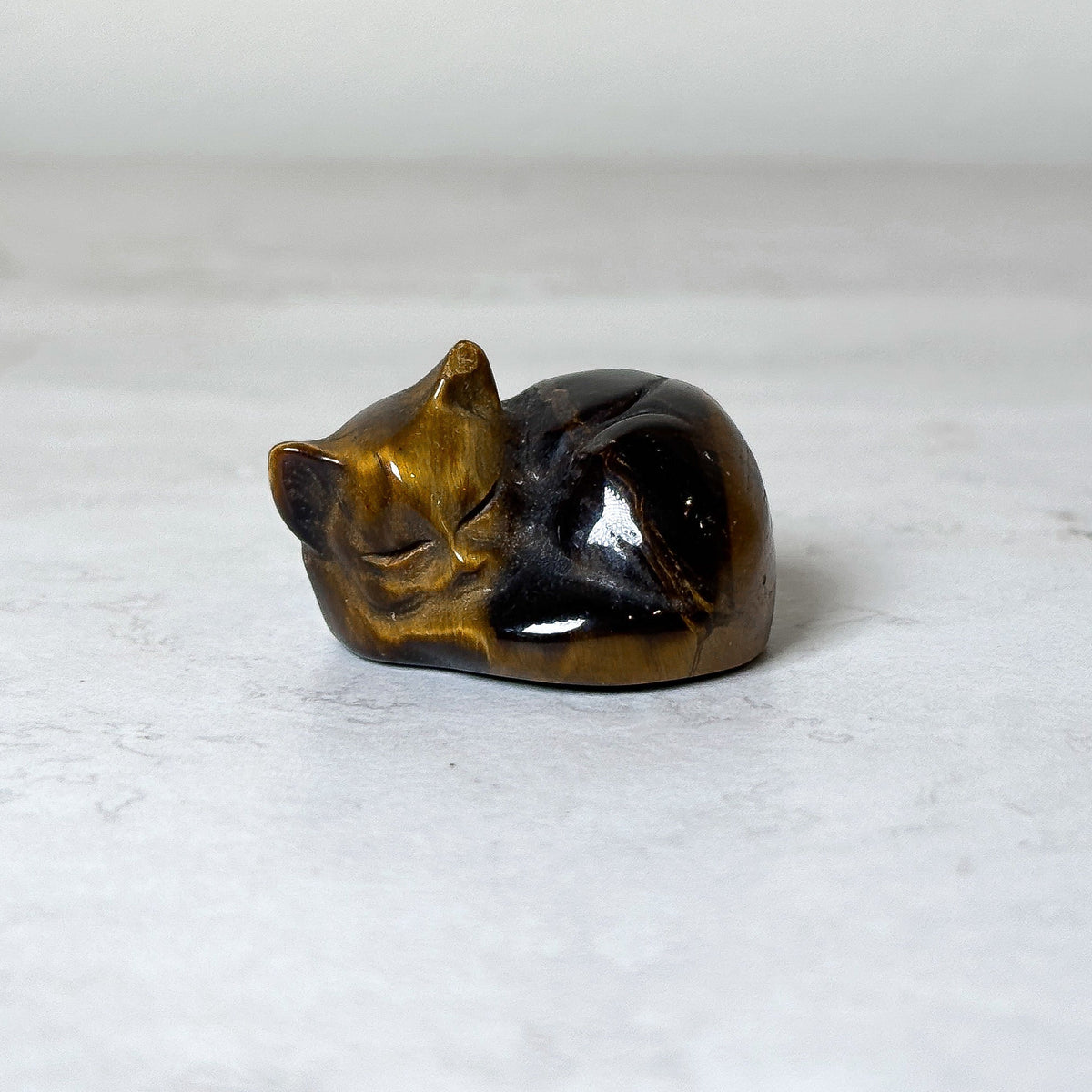 Polished sleeping cat crystal carving, view 5, at Ordinary Magic in Savannah, GA.