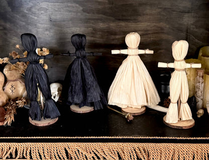 Black corn husk folk poppets shown together, at Ordinary Magic in Savannah, GA.
