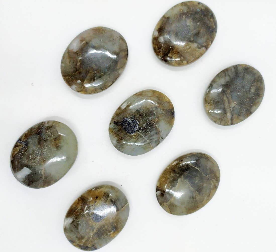 Polished labradorite worry stone, a pocket-sized thumb stone with blue flash, at Ordinary Magic in Savannah, GA.