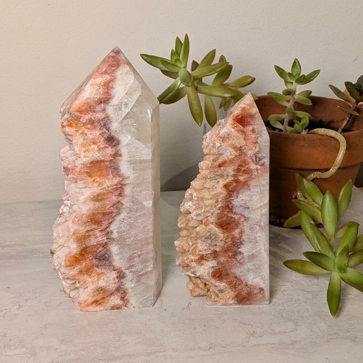Red calcite crystal tower with a sparkling druzy crystal face, at Ordinary Magic in Savannah, GA.