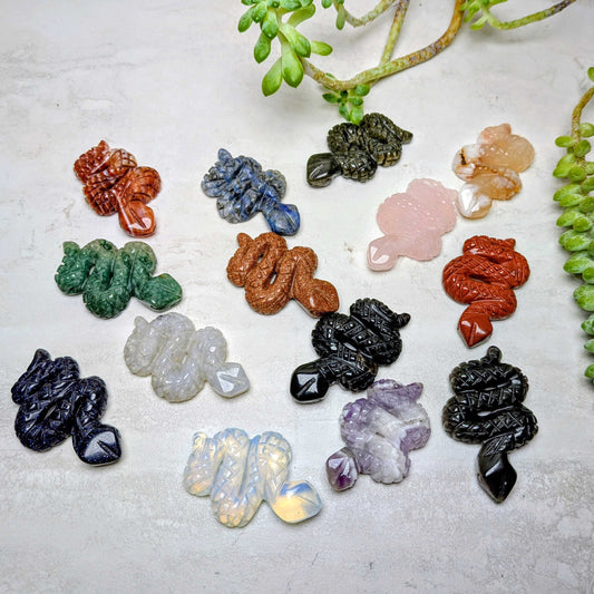 Carved crystal snake figures in an assortment of natural stones, at Ordinary Magic in Savannah, GA.
