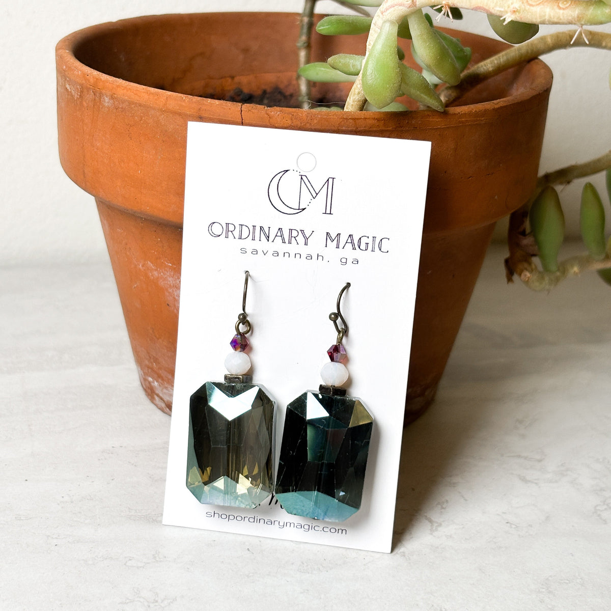 Translucent blue dangle earrings with small bead accents on fishhook ear wires