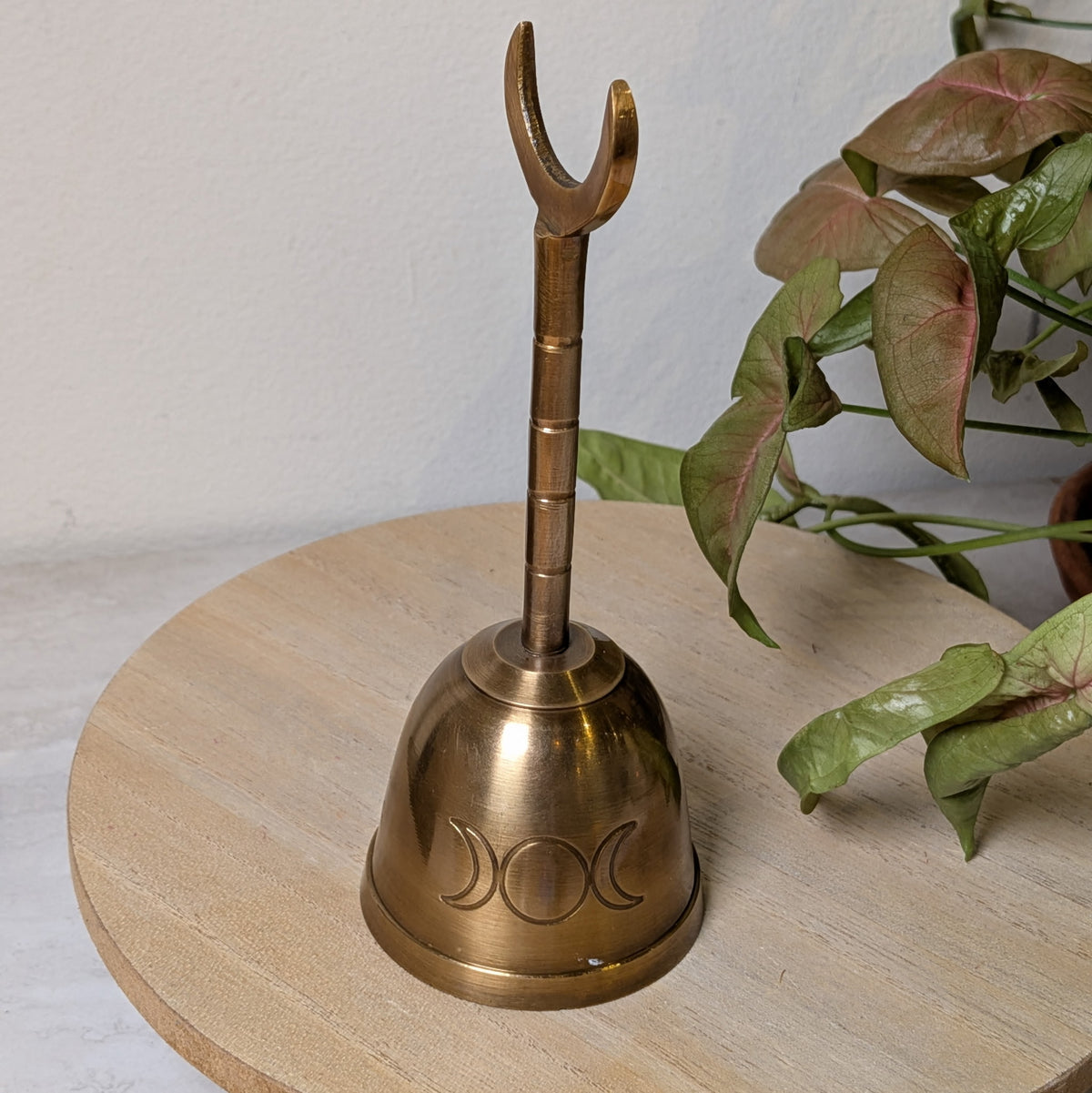 Solid brass Triple Moon altar bell, 5 inches tall, with crescent moon detailing, at Ordinary Magic in Savannah, GA.