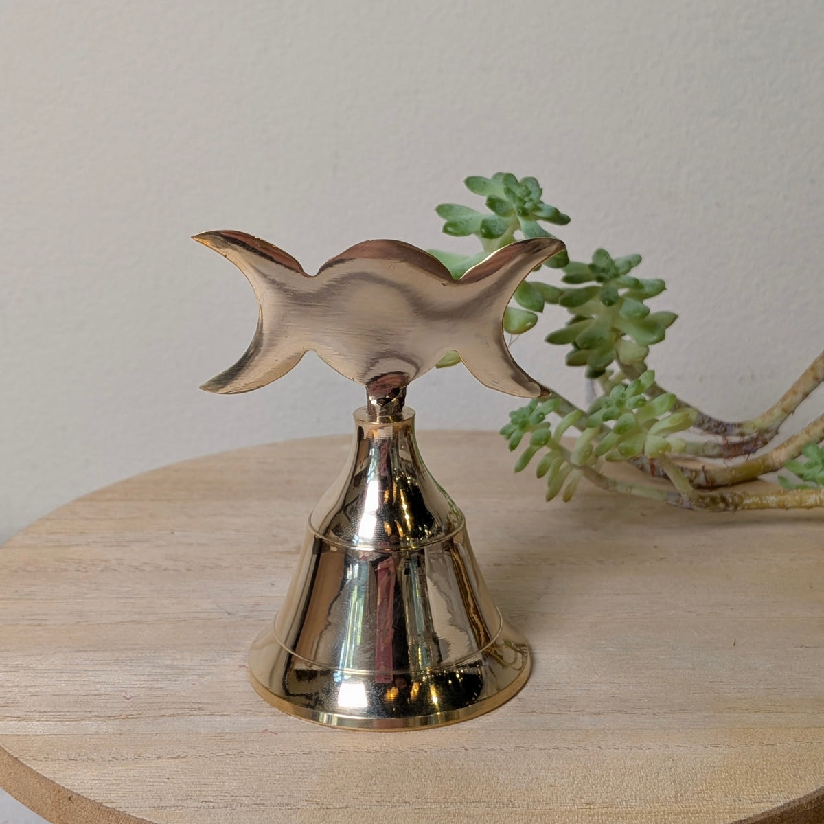 Triple Moon brass altar bell with an engraved waxing, full and waning moon design, at Ordinary Magic in Savannah, GA.