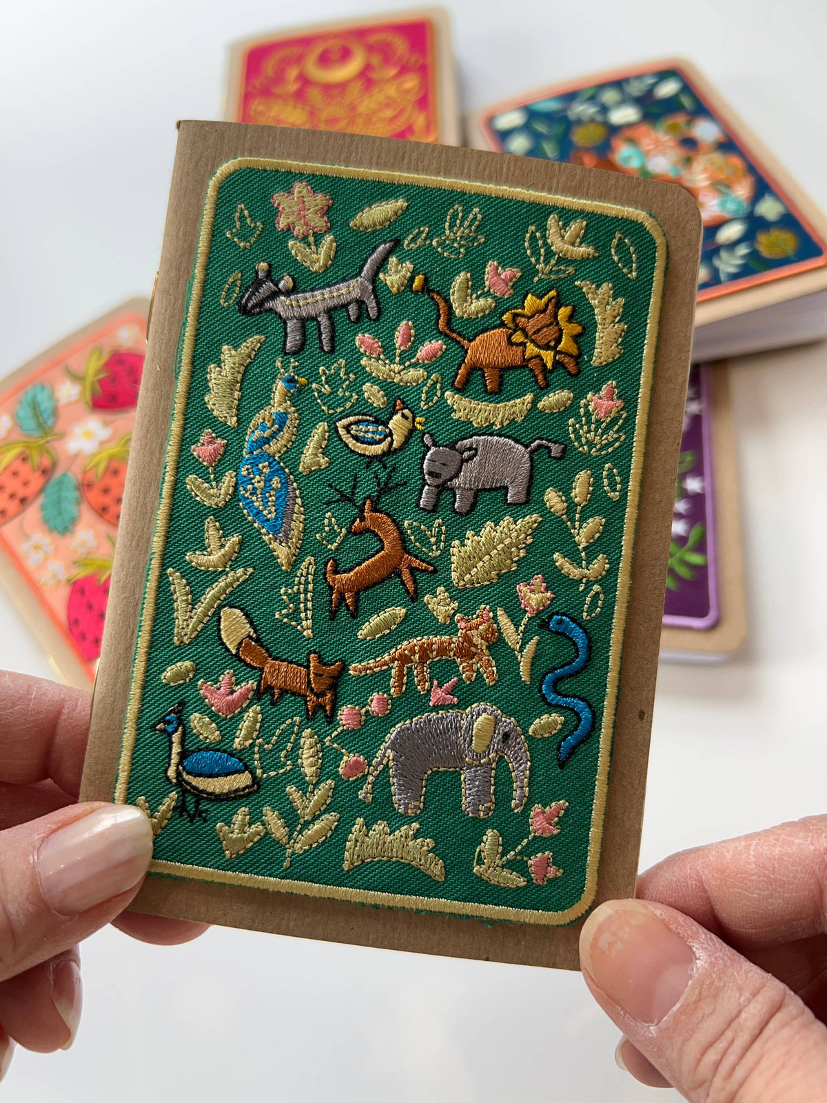 Wildlife embroidery pocket notebook, embroidered woodland animals with leaves and flowers on a kraft paper cover.