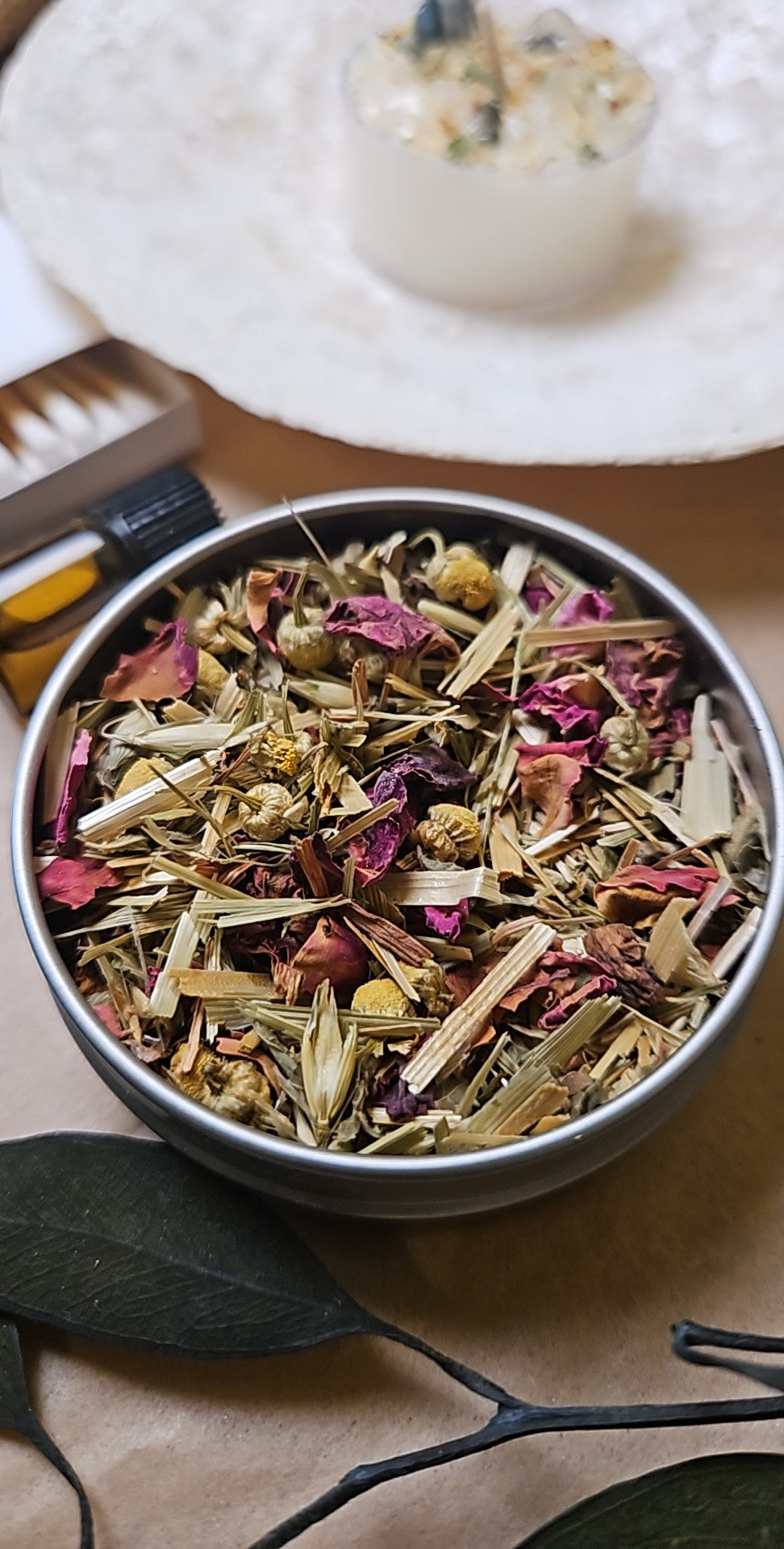Bowl of dried herbs and flowers on a textured surface with a blurred background
