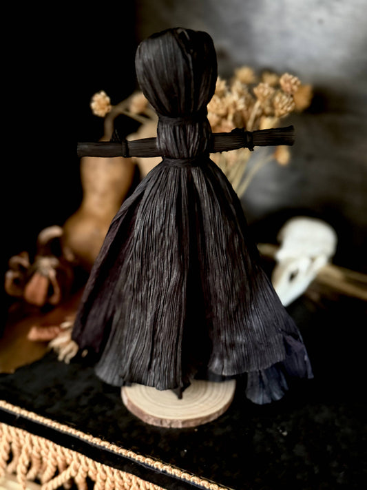 Black corn husk folk poppet with skirt, at Ordinary Magic in Savannah, GA.