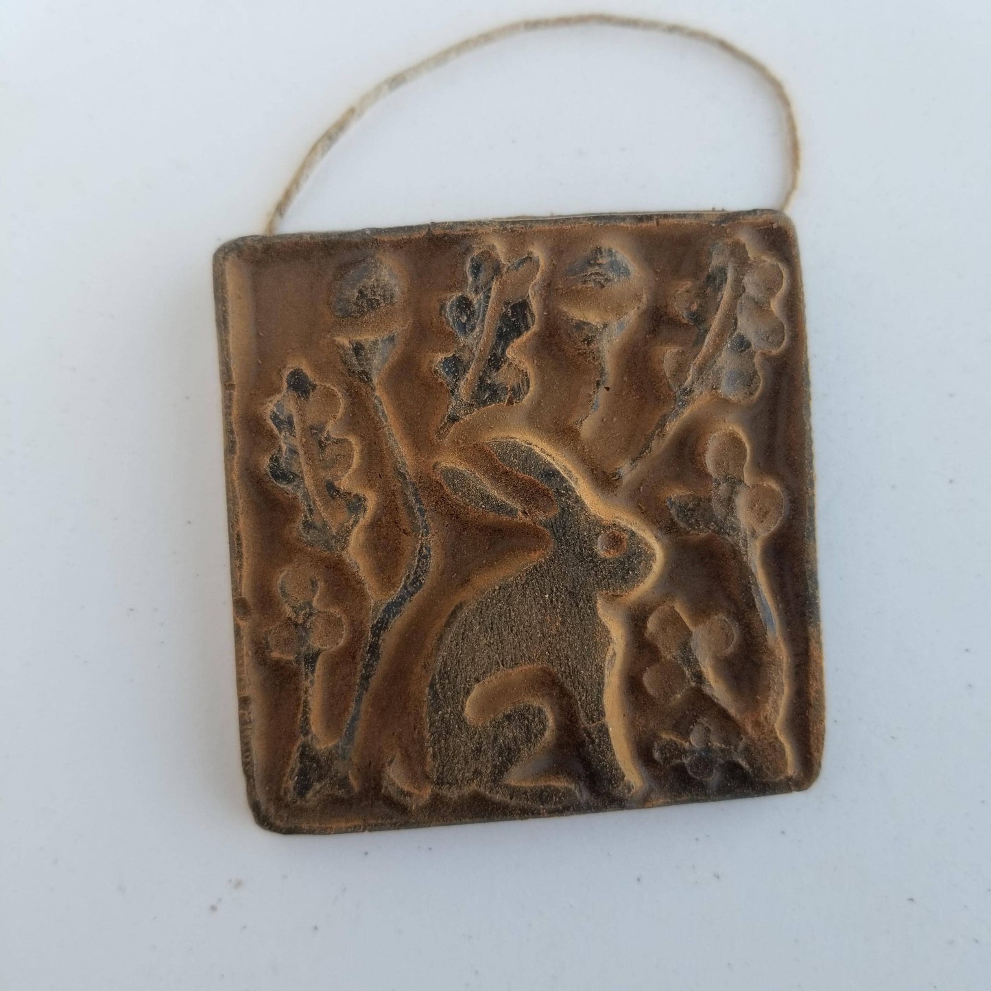 Decorative ceramic tile with animal design on a white background