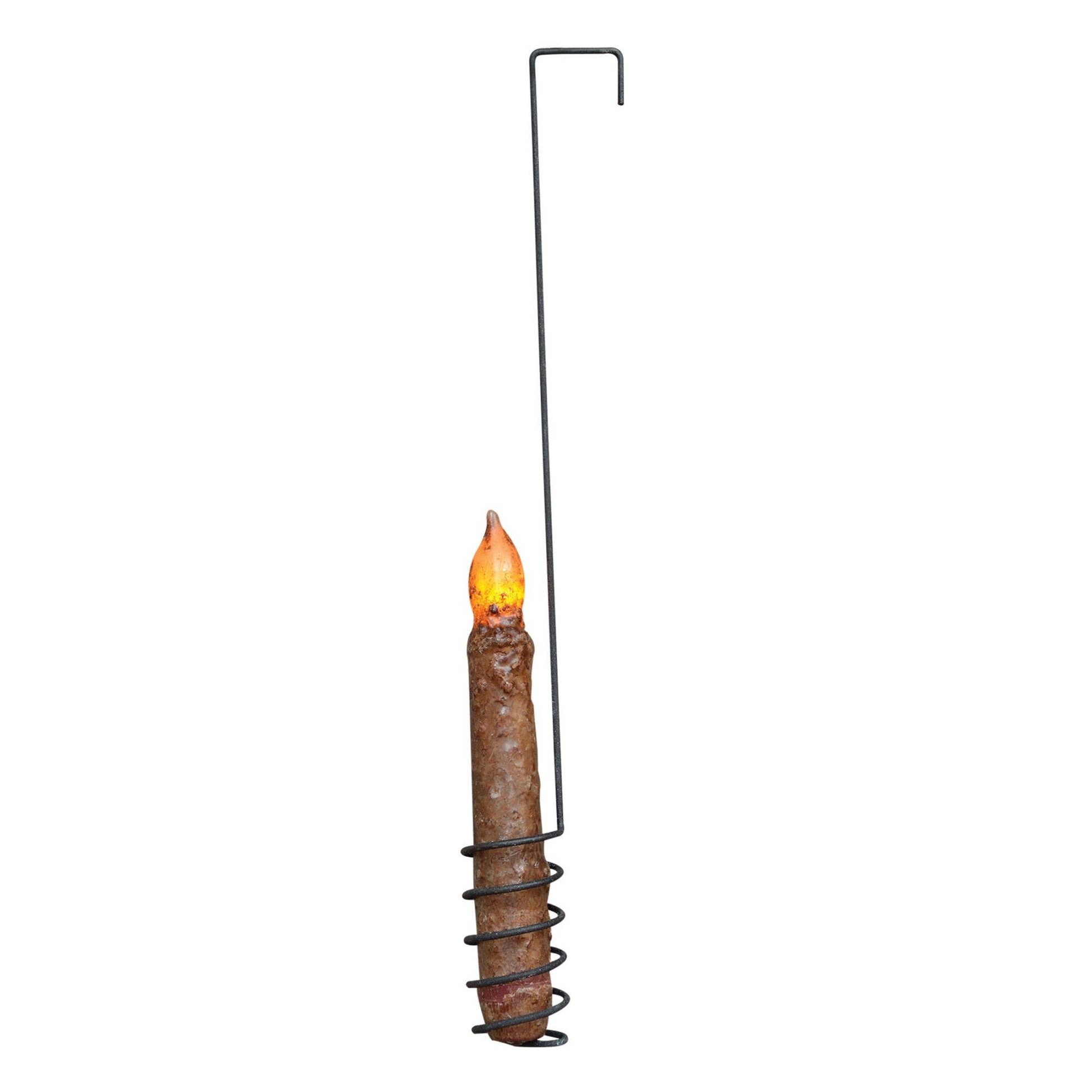 A rustic metal spiral candle holder with a faux brown candle and a glowing yellow-orange flame, shown against a plain white background.