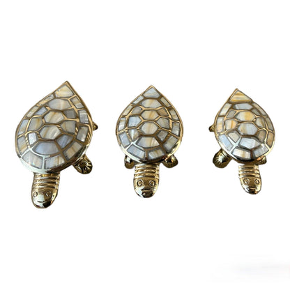 Three turtle-shaped decorative items with mosaic patterns on a white background