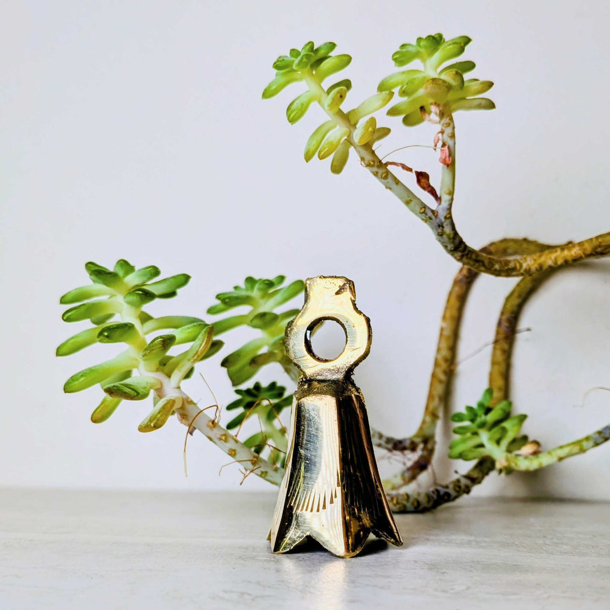 Handcrafted brass bell, one of six assorted designs, view 4, at Ordinary Magic in Savannah, GA.
