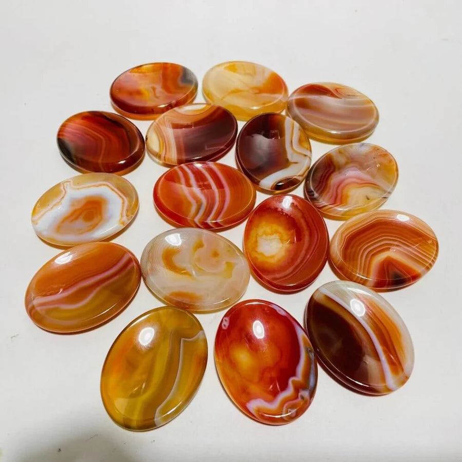 Collection of red marbled agate stones on a white background