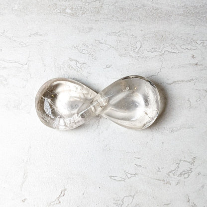 Clear quartz carved infinity symbol, polished and translucent