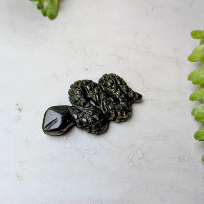 Carved crystal snake figure in gold sheen obsidian, at Ordinary Magic in Savannah, GA.