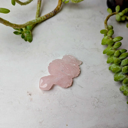 Carved crystal snake figure in rose quartz, at Ordinary Magic in Savannah, GA.