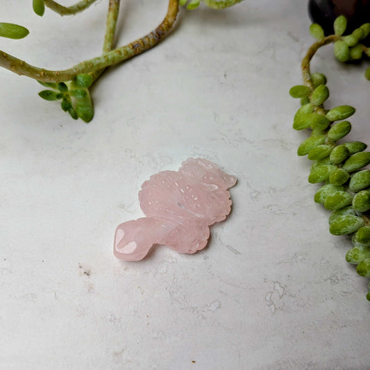 Carved crystal snake figure in rose quartz, at Ordinary Magic in Savannah, GA.