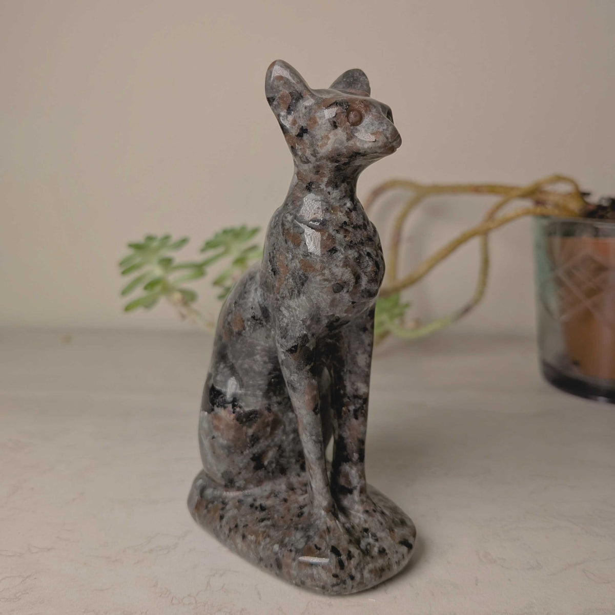 Carved crystal cat figures in larvikite and yooperlite, second view, at Ordinary Magic in Savannah, GA.