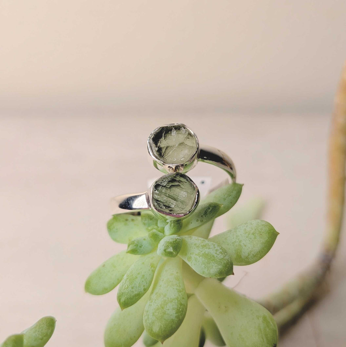 Green moldavite in a sterling silver bezel ring, natural textured surface