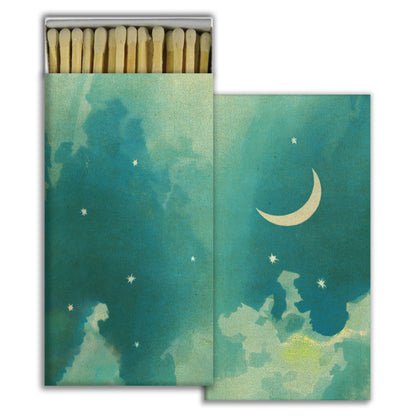 Matchbox with artistic design of a crescent moon and stars on a teal background
