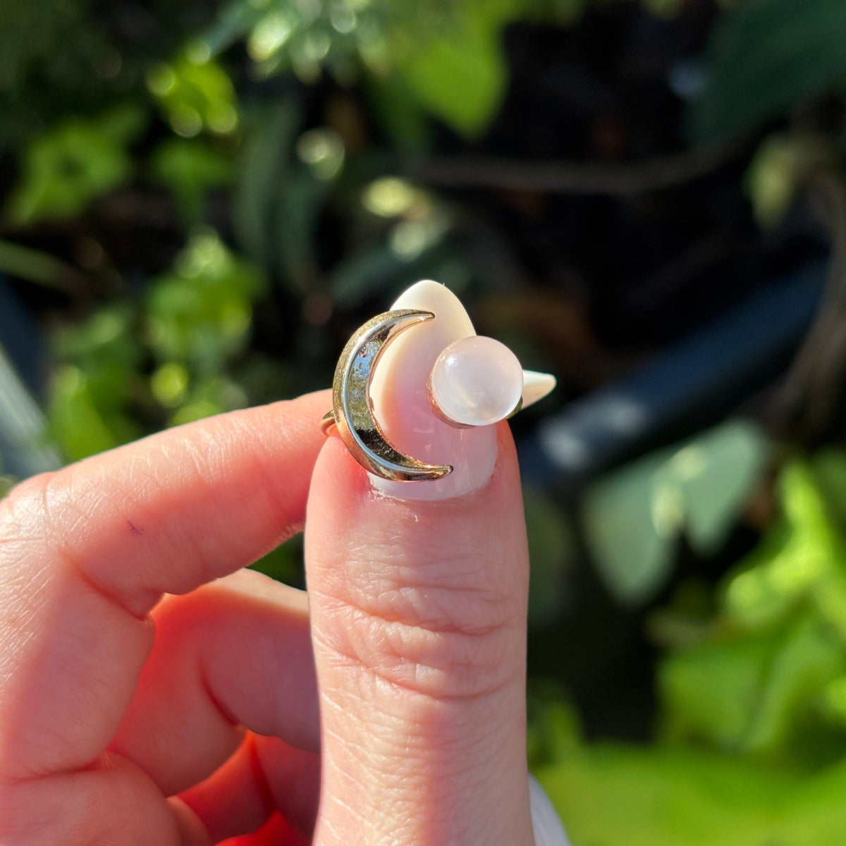 Moon and Ball Wrap Ring in gold tone with a milky moonstone-look ball, at Ordinary Magic in Savannah, GA.