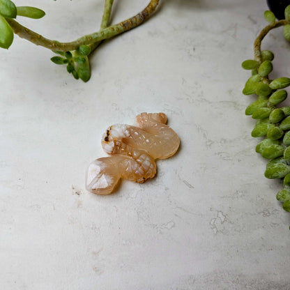 Carved crystal snake figure in flower agate, at Ordinary Magic in Savannah, GA.