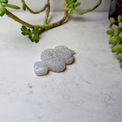 Carved crystal snake figure in rainbow moonstone, at Ordinary Magic in Savannah, GA.