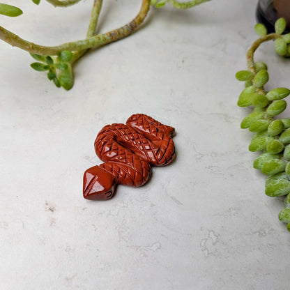 Carved crystal snake figure in red jasper, at Ordinary Magic in Savannah, GA.