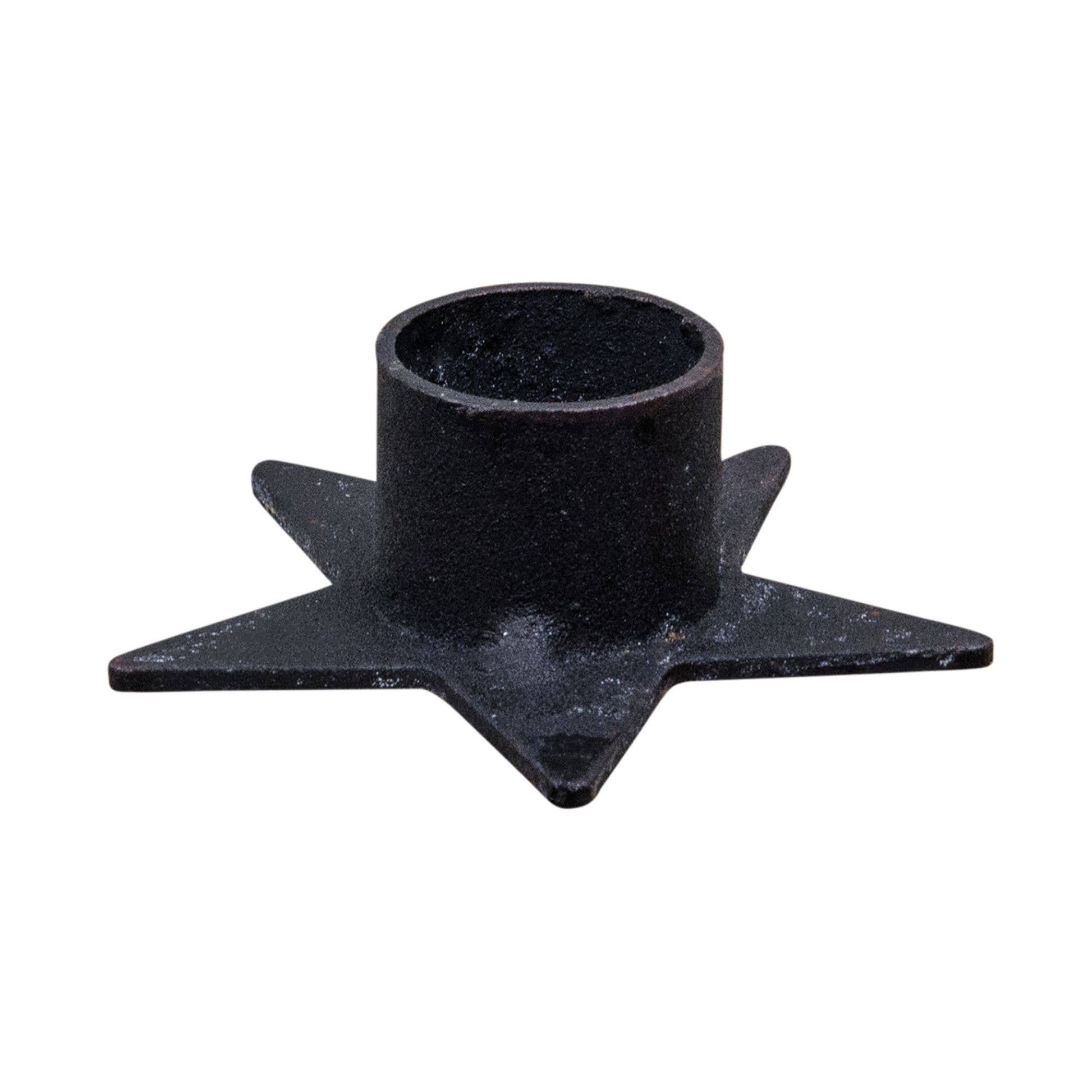 Star-shaped metal taper candle holder, at Ordinary Magic in Savannah, GA.