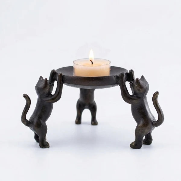 Antiqued brass-finish candle holder with three cats supporting a round platform