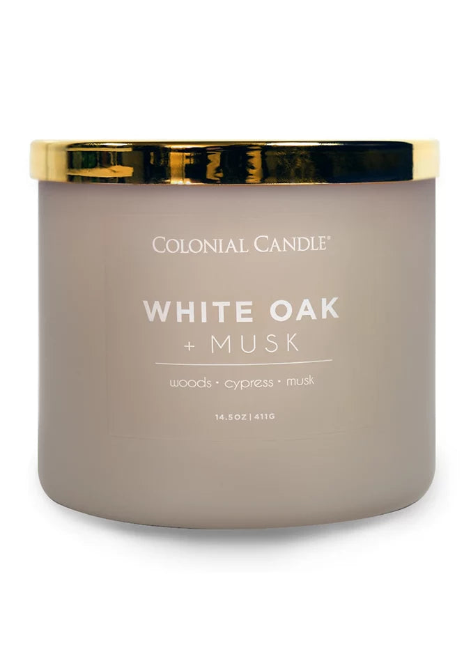 White Oak and Musk three-wick jar candle in taupe-beige glass with a gold lid