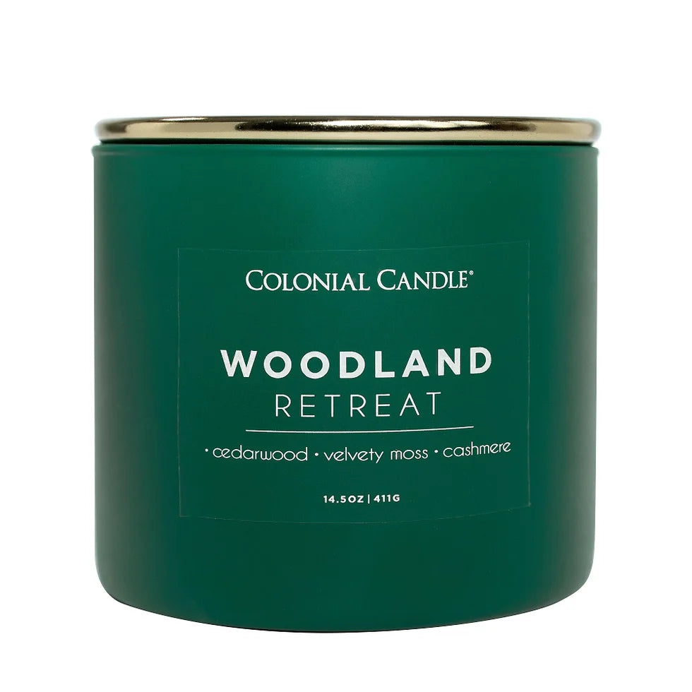 Woodland Retreat three-wick jar candle in dark green glass with a gold lid