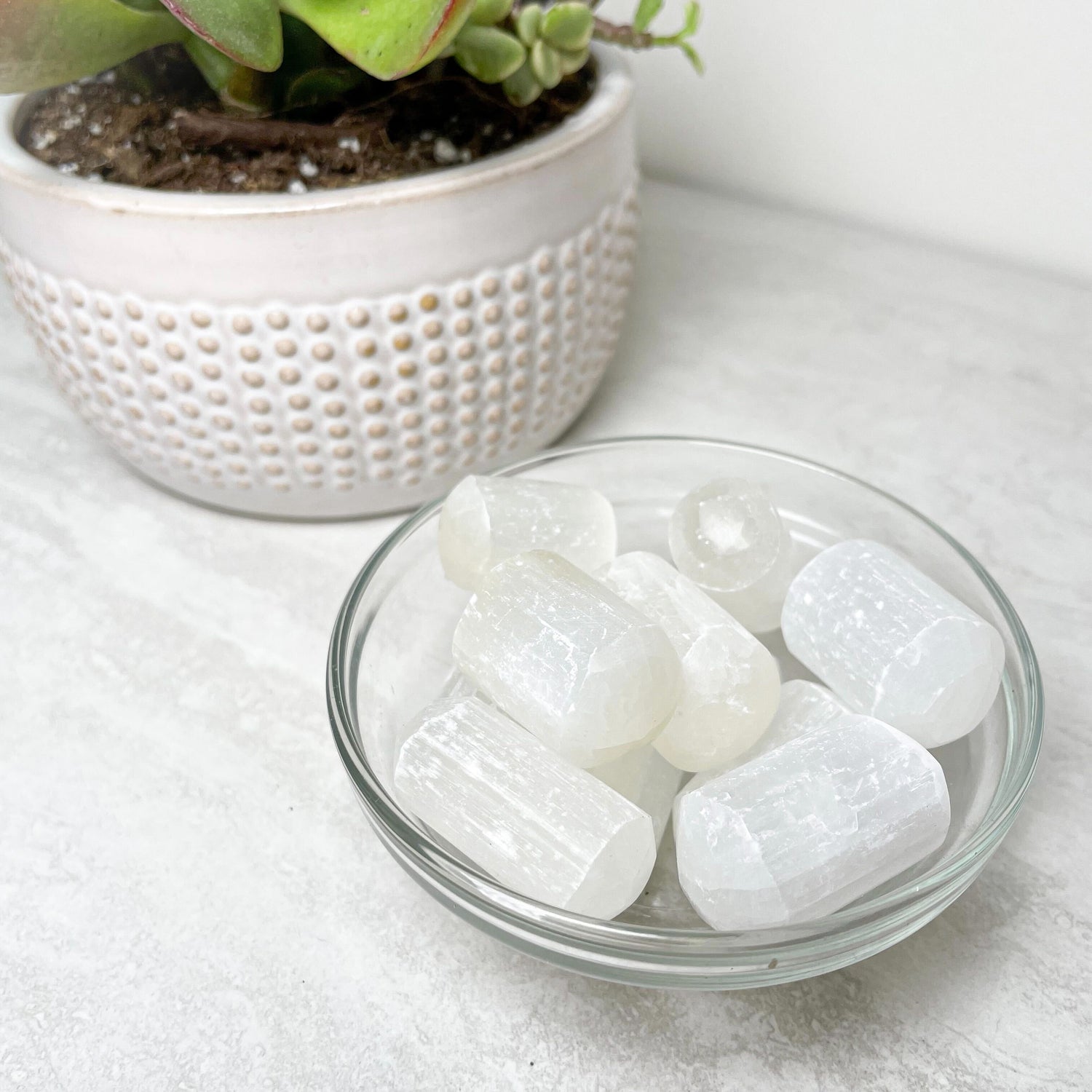 Tumbled white selenite stones with a soft pearly sheen.